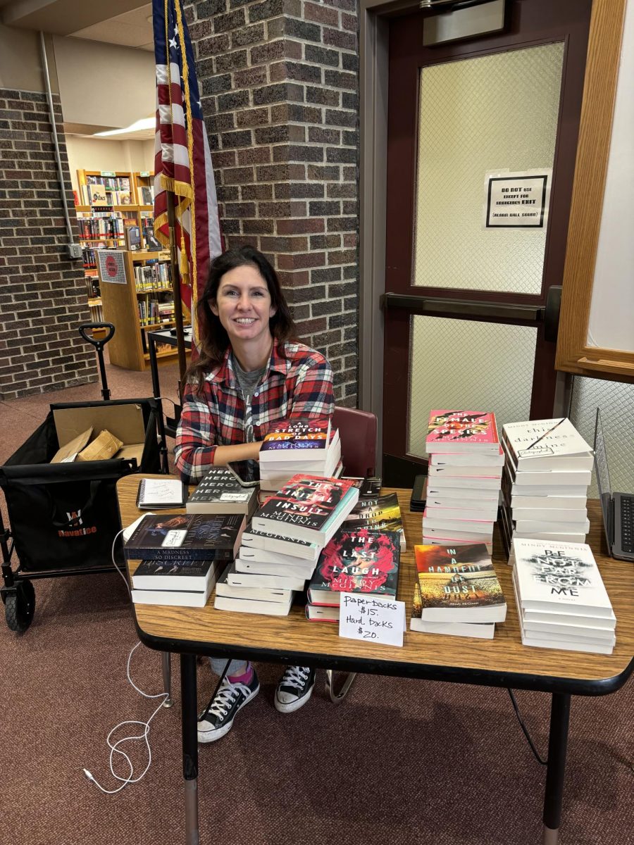 Author Mindy McGinnis shows off her books during a presentation in the South library.