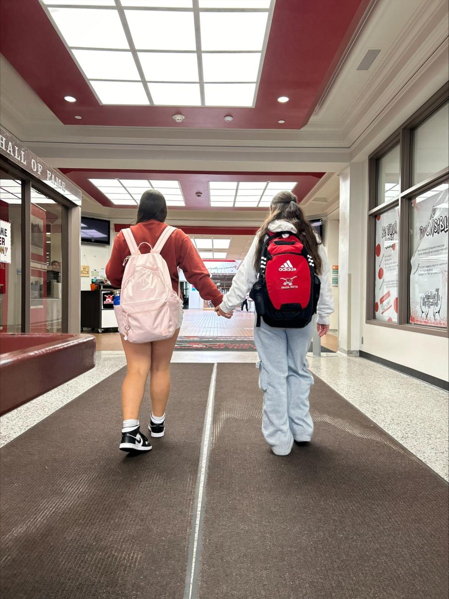 Itzelle Diaz and Alena Gutierrez walk through South's main entrance together.