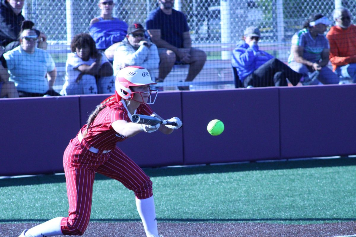  Makenzie Wolf laying a bunt down against Omaha North in game four of district.